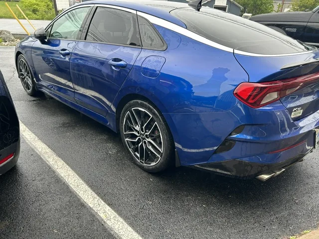 The finished blue sedan repaired and refinished